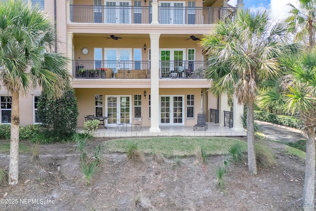 rear view of house featuring a balcony, a patio, ceiling fan, and french doors