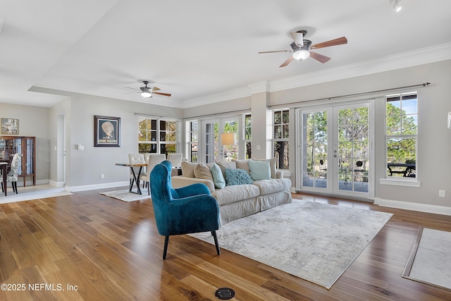 living room with hardwood / wood-style flooring, ornamental molding, ceiling fan, and french doors