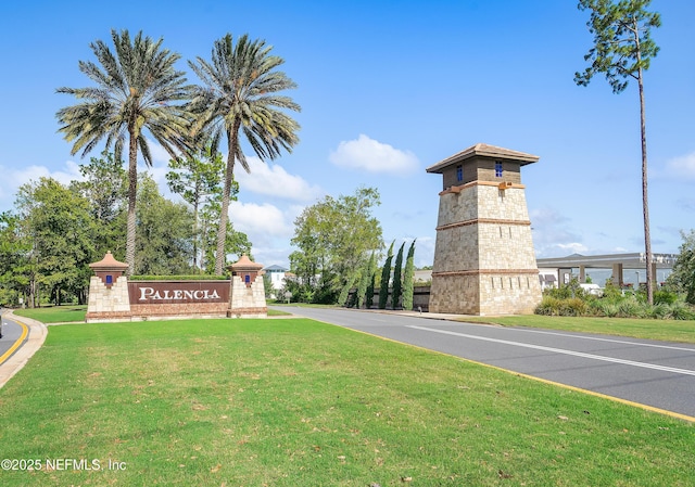 community sign featuring a lawn