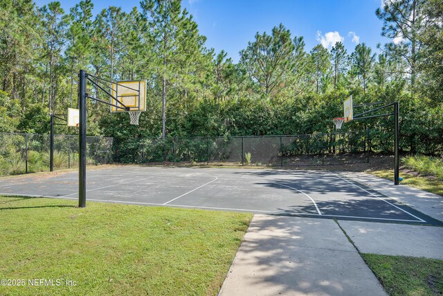 view of basketball court featuring a lawn