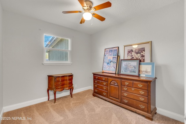 living area with light colored carpet and ceiling fan