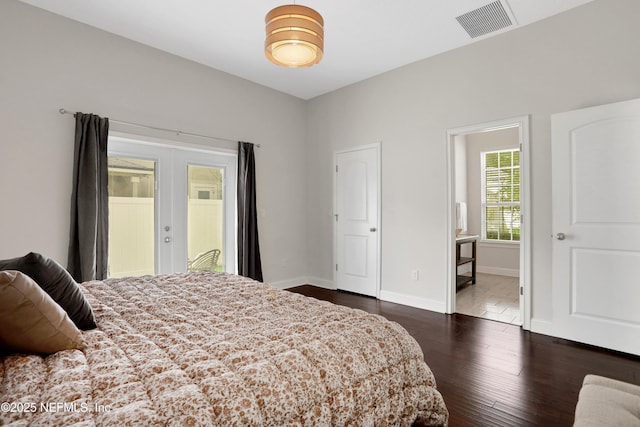 bedroom featuring dark wood-type flooring, connected bathroom, and french doors