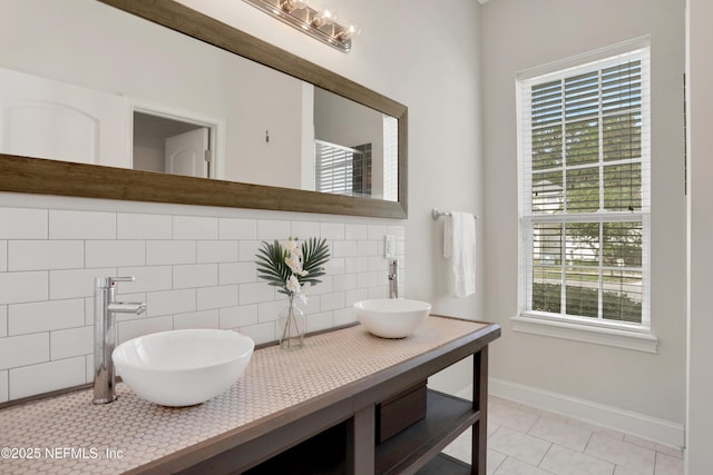 bathroom with tile patterned flooring, vanity, and backsplash