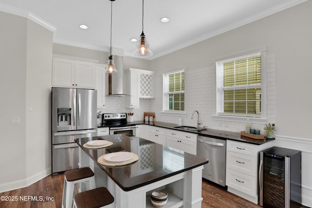 kitchen with wine cooler, white cabinets, hanging light fixtures, a center island, and stainless steel appliances