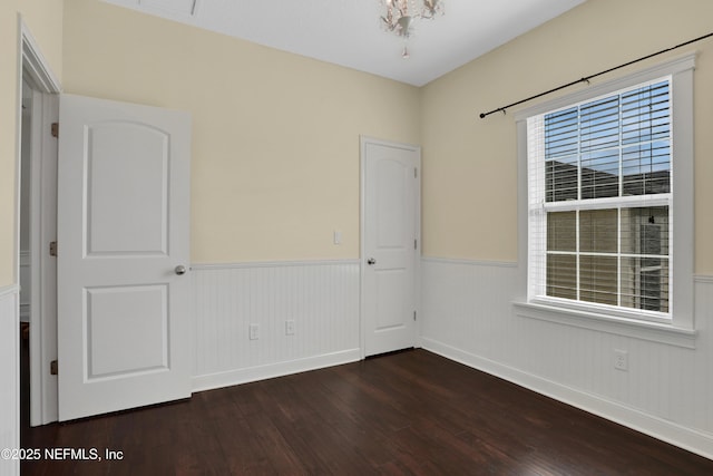 spare room featuring dark wood-type flooring