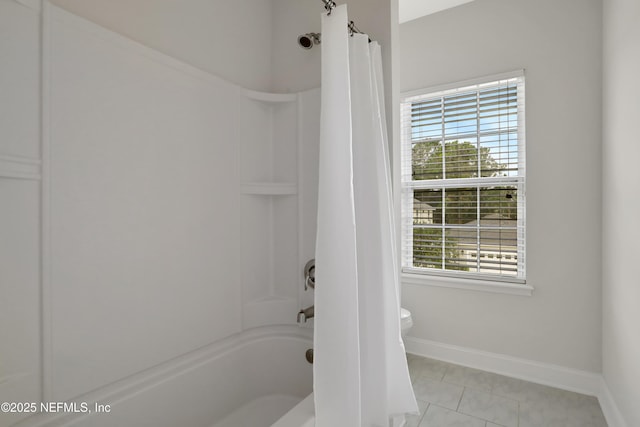 bathroom with shower / bath combination with curtain, tile patterned floors, and toilet