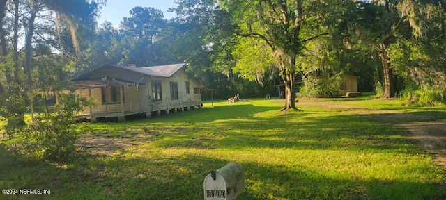 view of side of home with a lawn