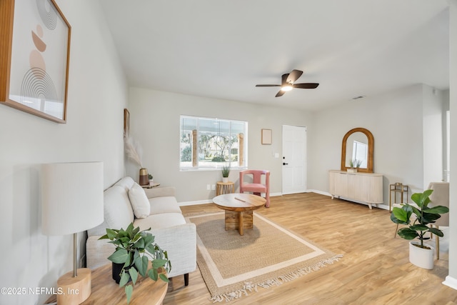 living room with hardwood / wood-style flooring and ceiling fan