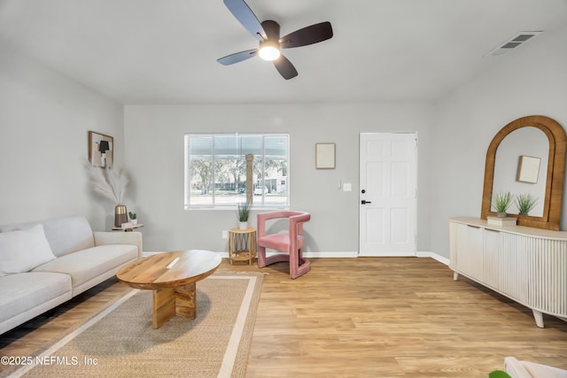 living room featuring ceiling fan and light wood-type flooring