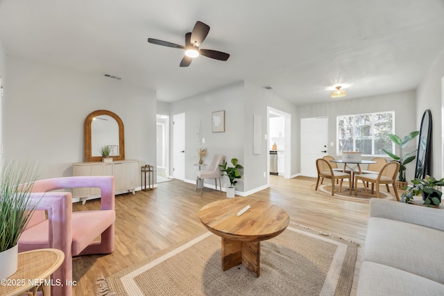 living room featuring ceiling fan and light wood-type flooring