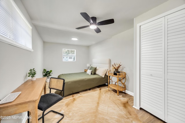 bedroom with ceiling fan and a closet