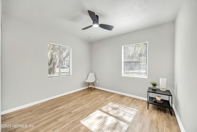 empty room with ceiling fan and light wood-type flooring