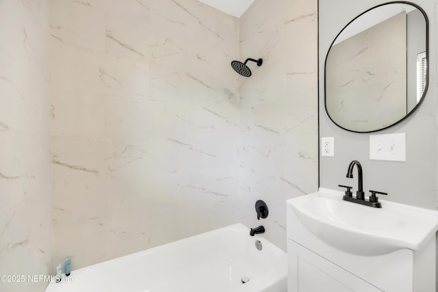 bathroom with tiled shower / bath and vanity