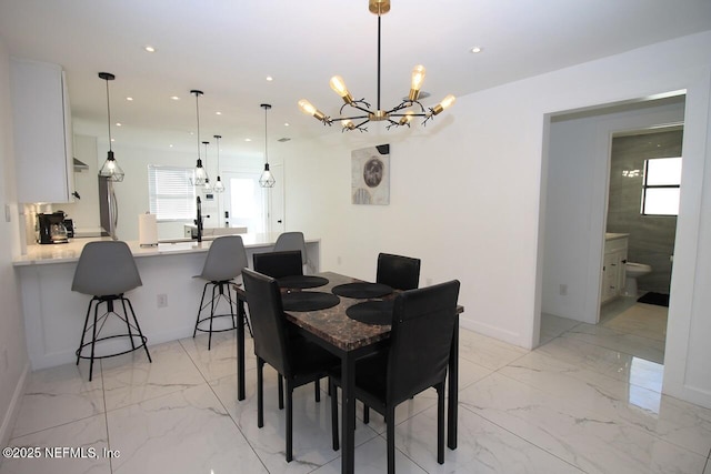 dining area with an inviting chandelier