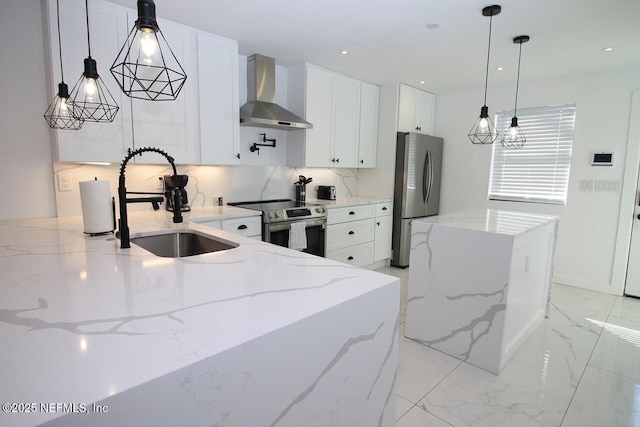 kitchen with stainless steel appliances, light stone countertops, white cabinets, and wall chimney exhaust hood