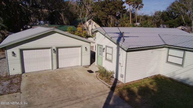 view of front facade featuring a garage and an outdoor structure