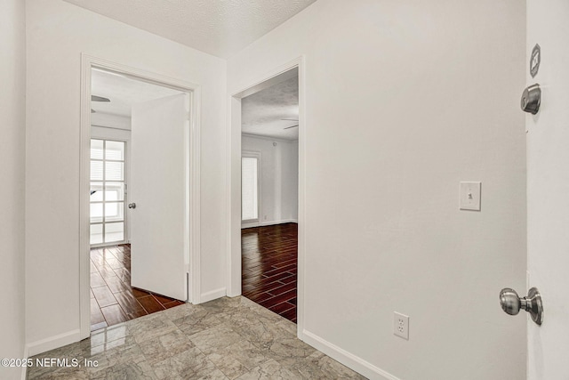 corridor featuring dark hardwood / wood-style floors and a textured ceiling