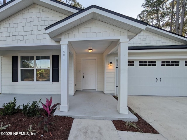 doorway to property with a garage