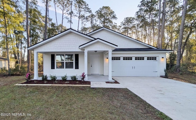 view of front of home with a garage and a front lawn