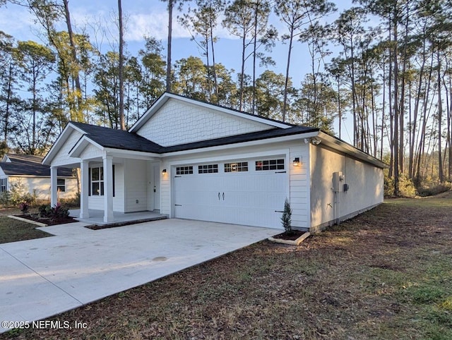 view of side of property with a garage and covered porch