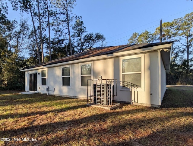 rear view of property featuring a yard