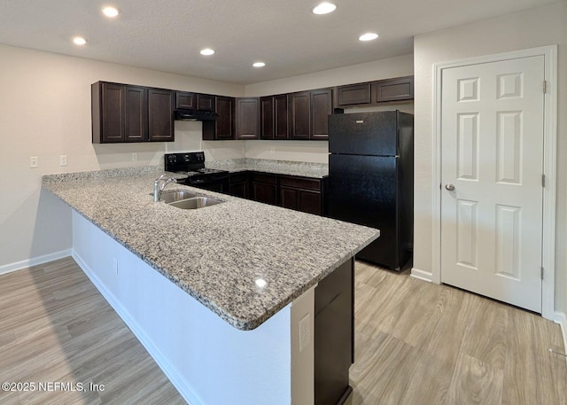 kitchen featuring light hardwood / wood-style flooring, light stone counters, dark brown cabinetry, black appliances, and kitchen peninsula