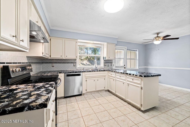 kitchen with ornamental molding, appliances with stainless steel finishes, kitchen peninsula, and sink