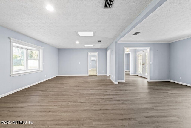 empty room featuring dark hardwood / wood-style flooring and a textured ceiling