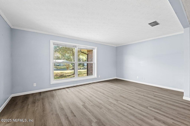 unfurnished room featuring crown molding, hardwood / wood-style floors, and a textured ceiling