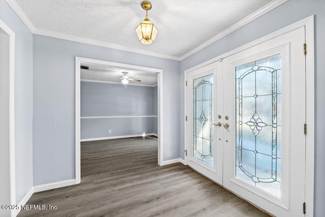 foyer entrance featuring ornamental molding, hardwood / wood-style floors, and a textured ceiling