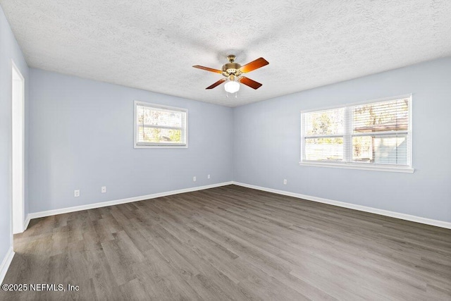 spare room with ceiling fan, dark wood-type flooring, and a textured ceiling