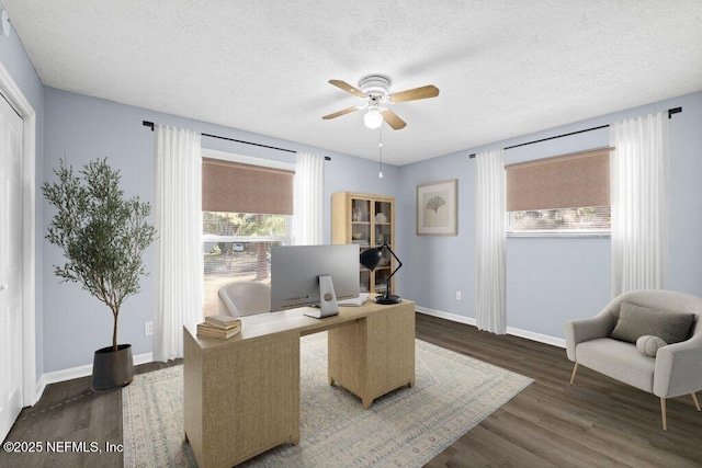 office area with ceiling fan, dark hardwood / wood-style floors, and a textured ceiling