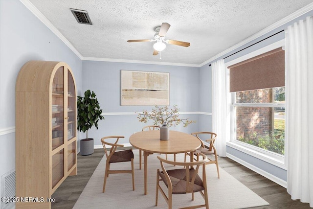 dining area featuring ornamental molding, ceiling fan, and dark hardwood / wood-style flooring