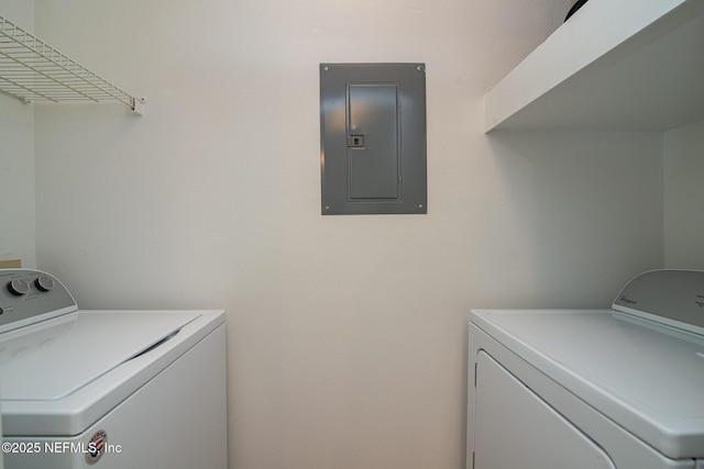 clothes washing area featuring electric panel and washer and dryer