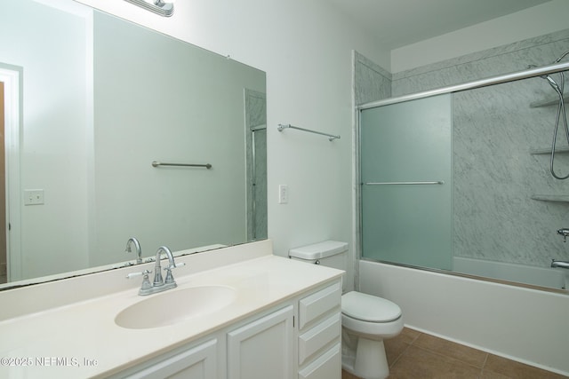 full bathroom with vanity, toilet, tile patterned flooring, and combined bath / shower with glass door