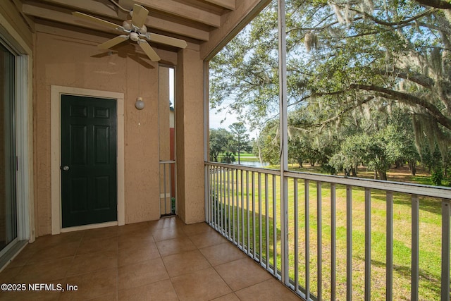 balcony featuring ceiling fan and a water view