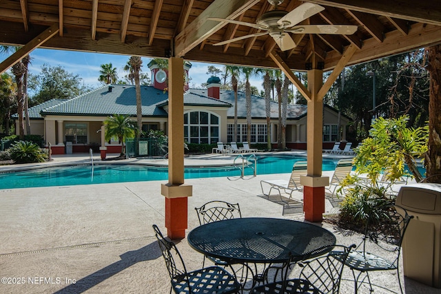 view of pool with a gazebo, ceiling fan, and a patio