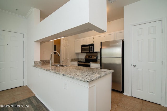 kitchen featuring sink, appliances with stainless steel finishes, kitchen peninsula, tile patterned flooring, and white cabinets