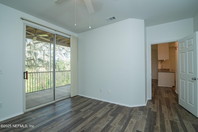 spare room with sink, dark hardwood / wood-style floors, and ceiling fan