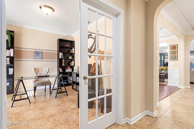 tiled home office with crown molding, a textured ceiling, and french doors