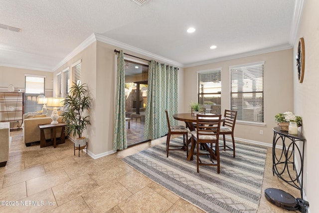 dining space with crown molding, plenty of natural light, and a textured ceiling