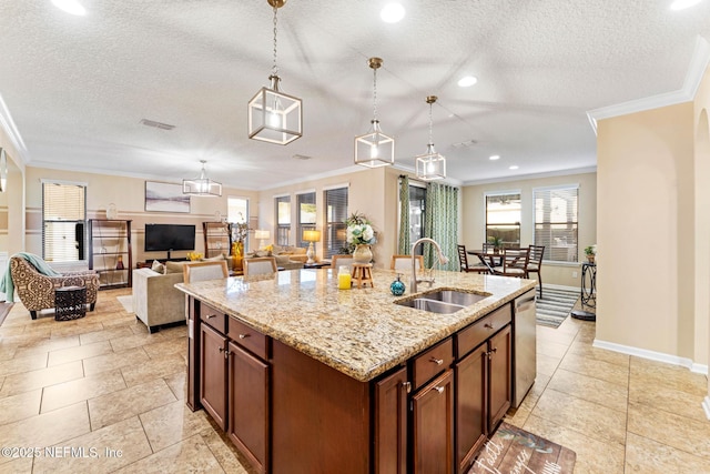 kitchen with sink, crown molding, decorative light fixtures, dishwasher, and an island with sink