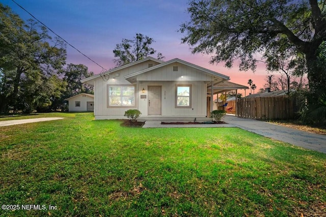 view of front facade with covered porch and a lawn