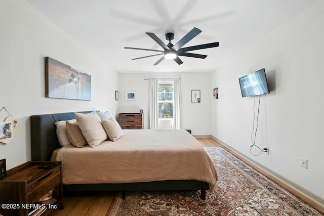 bedroom with hardwood / wood-style floors and ceiling fan