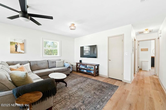 living room featuring ceiling fan and light wood-type flooring