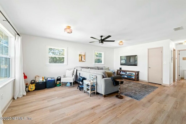 living room with ceiling fan and light hardwood / wood-style floors