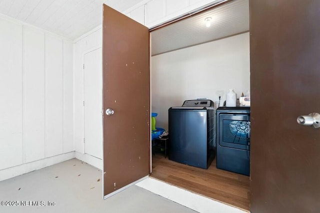 clothes washing area with washing machine and clothes dryer