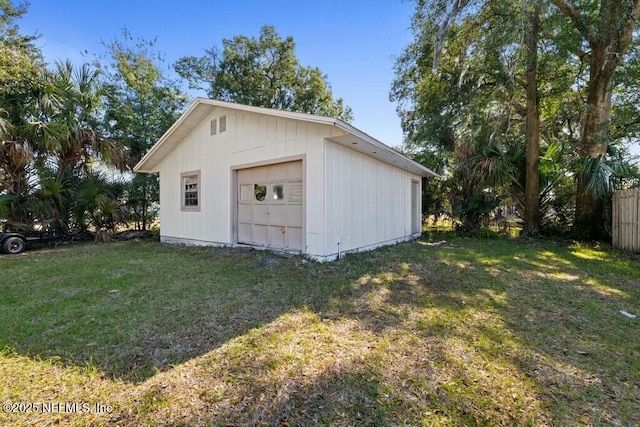 view of outdoor structure with a garage and a yard