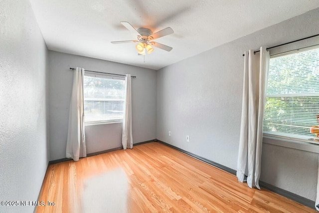 spare room featuring hardwood / wood-style flooring and ceiling fan