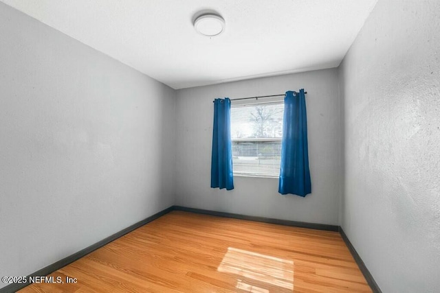 unfurnished room with hardwood / wood-style floors